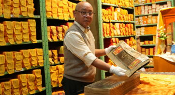 LTWA Library Director Mr. Sonam Topgyal displays a text from the Manuscripts Division.